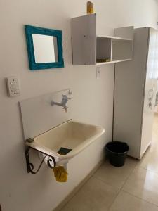 a bathroom with a sink and a mirror on the wall at Vivendas do Serrano Apart105 Lençois in Lençóis