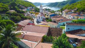 an aerial view of a village with a church and a river at Pousada do imperador in Piranhas