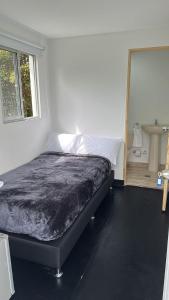 a bedroom with a bed and a window and a sink at Hostal Vallegrande in Rionegro