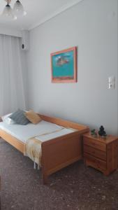 1 dormitorio con 1 cama y una foto en la pared en LENIA, en Nea Plagia