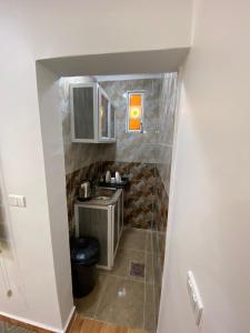 a small bathroom with a sink and a counter at Petra Main Gate Studios in Wadi Musa