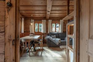 a dining room and living room in a log cabin at Chalet Laugenblick in Santa Valpurga