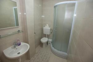 a bathroom with a shower and a toilet and a sink at Rooms Ivana in Međugorje