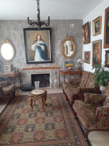 a living room with a couch and a fireplace at Casa galería de arte in Quito