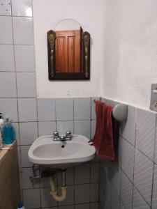 a small bathroom with a sink and a mirror at Casa galería de arte in Quito