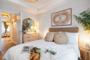 a bedroom with a bed with a tray of food on it at Notting Hill Apartments Collection in London