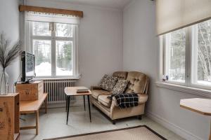 a living room with a couch and a table at Rustic home surrounded by forest in Skellefteå in Skellefteå