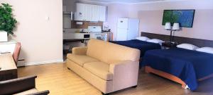 a living room with a couch and a kitchen at Fairview Inn in Fairview