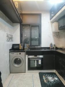 a small kitchen with a washing machine in it at Hassan Rabat in Rabat