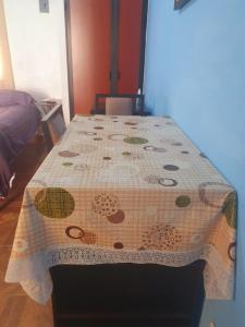 a table with a flowered table cloth on it at ESTUDIO EL ANGEL. in Santa Cruz Huatulco