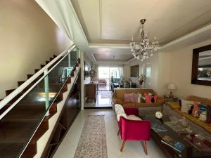 a living room with a couch and a chandelier at Hotel Pousada Irmaos Freyhardt in Rio de Janeiro