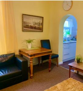 a living room with a wooden table and two chairs at Apartments near the sea with free parking Southend-on-Sea in Southend-on-Sea