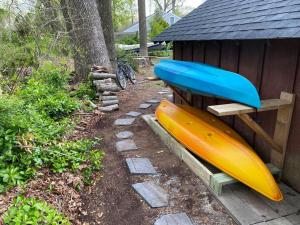 two surfboards sitting on a bench next to a house at Cottage by the bay, sleeps 8 near Rehoboth beach in Lewes