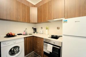 a kitchen with a washer and a white appliance at Cozy 2-Bedroom Flat in the very Center of Sofia in Sofia +21 photos