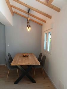 a dining room with a wooden table and chairs at Nice family house in Hendaye