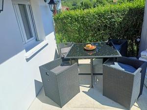 a table with a bowl of fruit on it on a patio at Nice family house in Hendaye