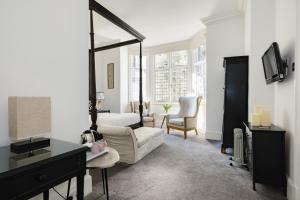 a living room with a couch and a chair at The Abbey Notting Hill in London