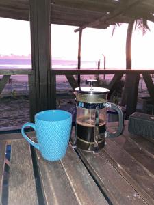 une cafetière et une tasse assise sur une table dans l'établissement Eco cabaña Mimi, à Tuxpan