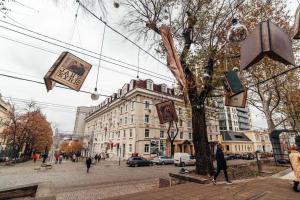 a street with some pictures hanging from a tree at Cathedral Park and Pedestrian zone ultracentral cozy apartment in Chisinau in Chişinău