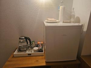 a small refrigerator sitting on top of a wooden table at Chambre privé dans belle maison 2 in Ettelbruck