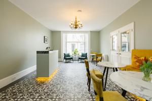 a living room with a table and chairs at The Abbey Notting Hill in London