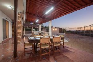 an outdoor dining room with a table and chairs at Casa Centenario: Lovely 3br home w/ heated Pool great for families in El Centenario