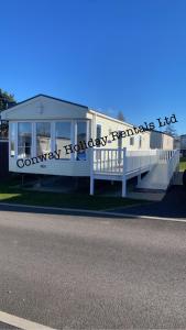 a white house with a sign on the side of it at Caravan for Hire Marton Mere Blackpool in Blackpool