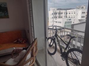 Una bicicleta sentada en un balcón con sofá en B&B in Floridablanca with a pool, en Floridablanca