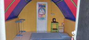 a room with a colorful room with a bed and a door at Curug Ciherang Villa & Glamping in Nangeleng
