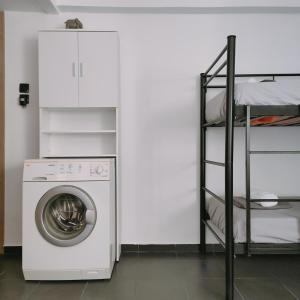 a washing machine in a room with a shelf at Seaside apartment in Agioi Theodoroi