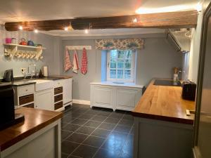 a kitchen with a sink and a window in it at High Moor Cottage in Baronheld
