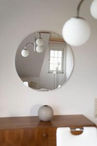 a mirror on top of a table in a room at Idyllische Wohnung mit Weitblick in Neukirchen-Vluyn