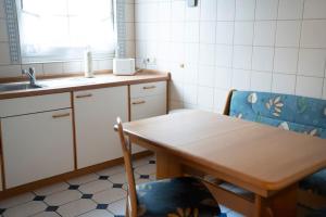 a kitchen with a table and two chairs and a sink at Idyllische Wohnung mit Weitblick in Neukirchen-Vluyn +15 photos