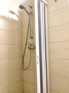 a shower with a shower head in a bathroom at Dimora Anna - Puglia Mia Apartments in Monopoli