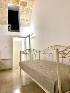 a bedroom with a bed and a flat screen tv at Dimora Anna - Puglia Mia Apartments in Monopoli