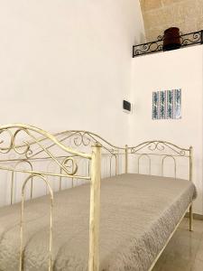 a bedroom with a metal bed in a room at Dimora Anna - Puglia Mia Apartments in Monopoli
