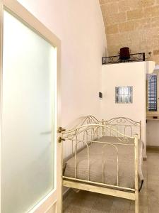 a bedroom with a bed and an open door at Dimora Anna - Puglia Mia Apartments in Monopoli