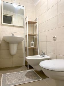 a bathroom with a sink and a toilet at Dimora Anna - Puglia Mia Apartments in Monopoli