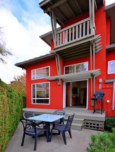 a red house with a table and chairs in front of it at Villas at Eldorado Resort in Kelowna