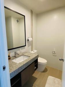 a bathroom with a sink and a toilet and a mirror at Habitación en miraflores in Lima