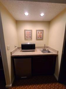 a kitchen with a sink and a microwave at Best Western Hickory in Hickory