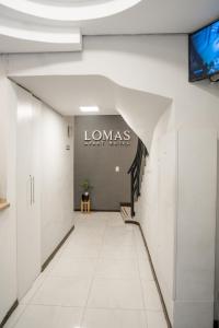 a hallway in a building with a sign on the wall at Lomas Apart Hotel in Mendoza