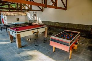 a room with a pool table and two tables at Sitio Vila Cristina - Mogi in Mogi das Cruzes