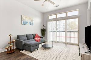 a living room with a couch and a tv at The Isabella: Riverwalk Loft in San Antonio