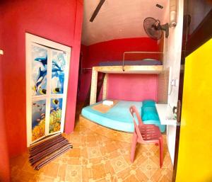 a room with a bunk bed and a chair in it at Rumah Hentian Ayah in Kuala Besut