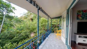 a balcony with a view of the forest at The Butterfly House, Beautiful Home Near The Beach in Horseshoe Bay