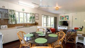 a kitchen with a dining room table and chairs at The Butterfly House, Beautiful Home Near The Beach in Horseshoe Bay
