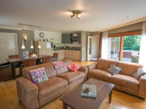 a living room with a couch and a table at Villa Maashorst in Uden