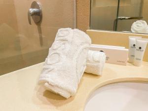 a white towel sitting on top of a bathroom sink at Madison 101 Hotel + Tower in Manila