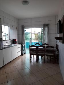 a kitchen with a table and chairs in a room at Apartamentos de Penha in Penha